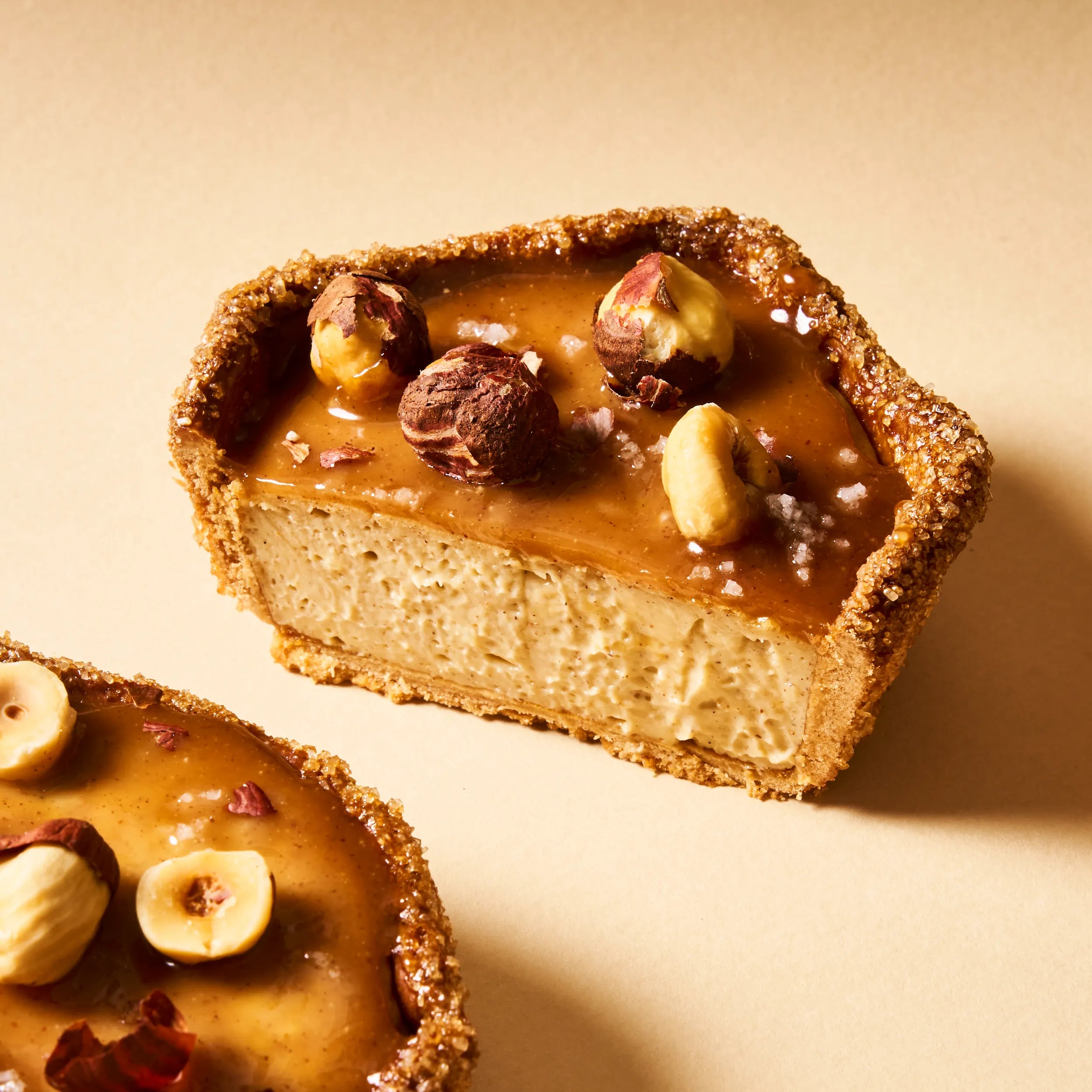 Part de flan noisette en biais montrant la générosité de la garniture vanille et le croûtage caramélisé à la cassonade de la pâte sucrée.